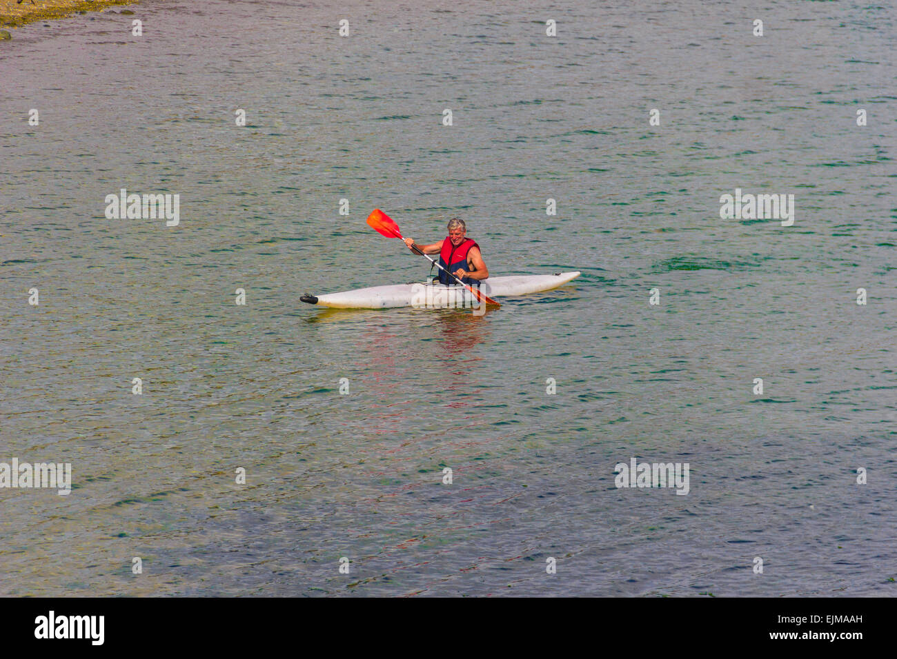 Personne seule kayak sur la baie de Cardigan à Criccieth, Nord du Pays de Galles, Royaume-Uni. Banque D'Images