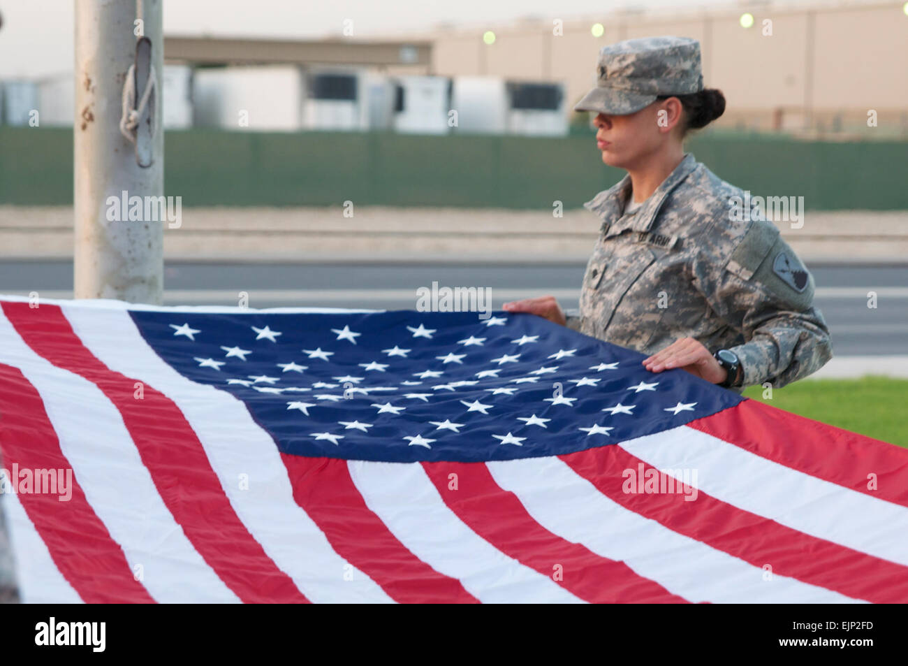 Un soldat sur le drapeau détail se prépare à plier d'antan dans le cadre d'un réveil quotidien cérémonie tenue le 24 octobre au Camp Arifjan, au Koweït. Le drapeau a été présenté à Brigue. Le général Donald Tatum, général commandant de la 135ème commande soutien expéditionnaire. Cet ensemble particulier d'Étoiles et bandes de soutien de l'Armée survolaient le quartier général Group-Kuwait pour 211 jours, une période qui a coïncidé avec l'heure par hasard Tatum et ses troupes avait commandé un grand nombre de missions logistique menée sous le commandement central américain sa zone d'opérations. Plus tôt dans la journée, la Garde nationale de l'Alabama a mené un transf Banque D'Images