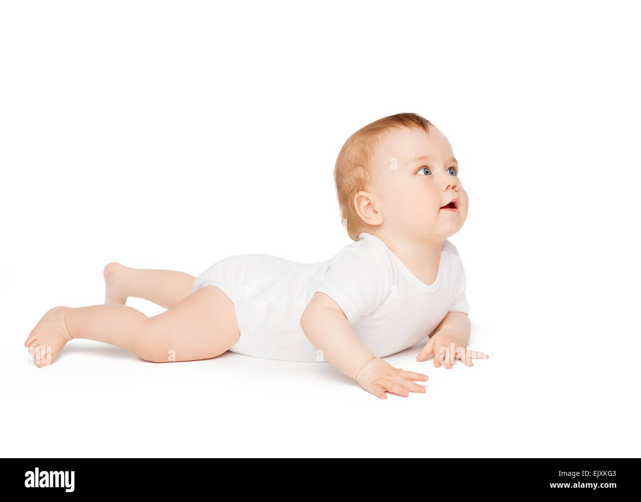 Smiling baby lying on floor and looking up Banque D'Images