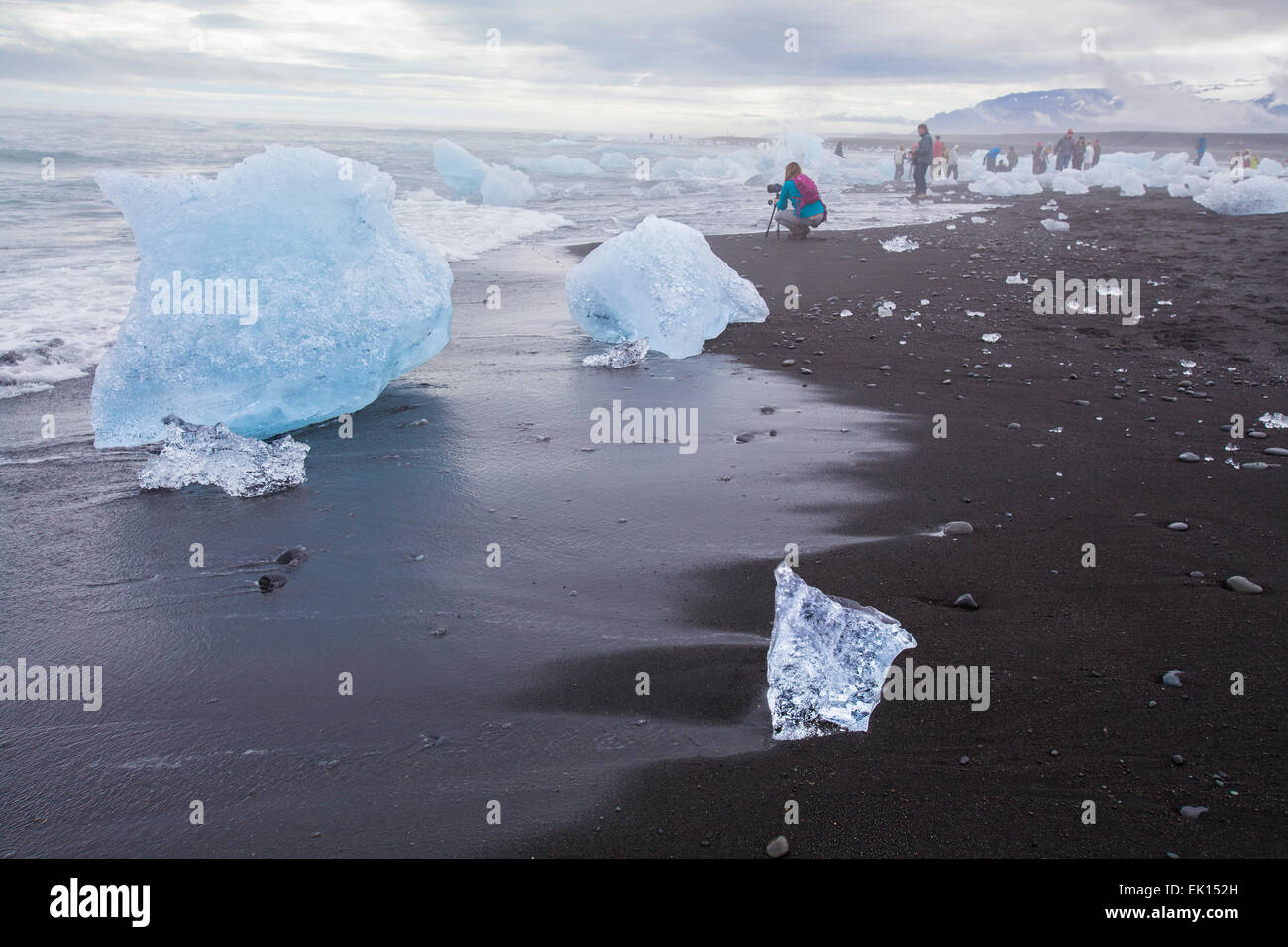 Voir des gens prendre des photos d'icebergs à l'océan près de la lagune glaciaire du Jökulsárlón dans le sud de l'Islande Banque D'Images