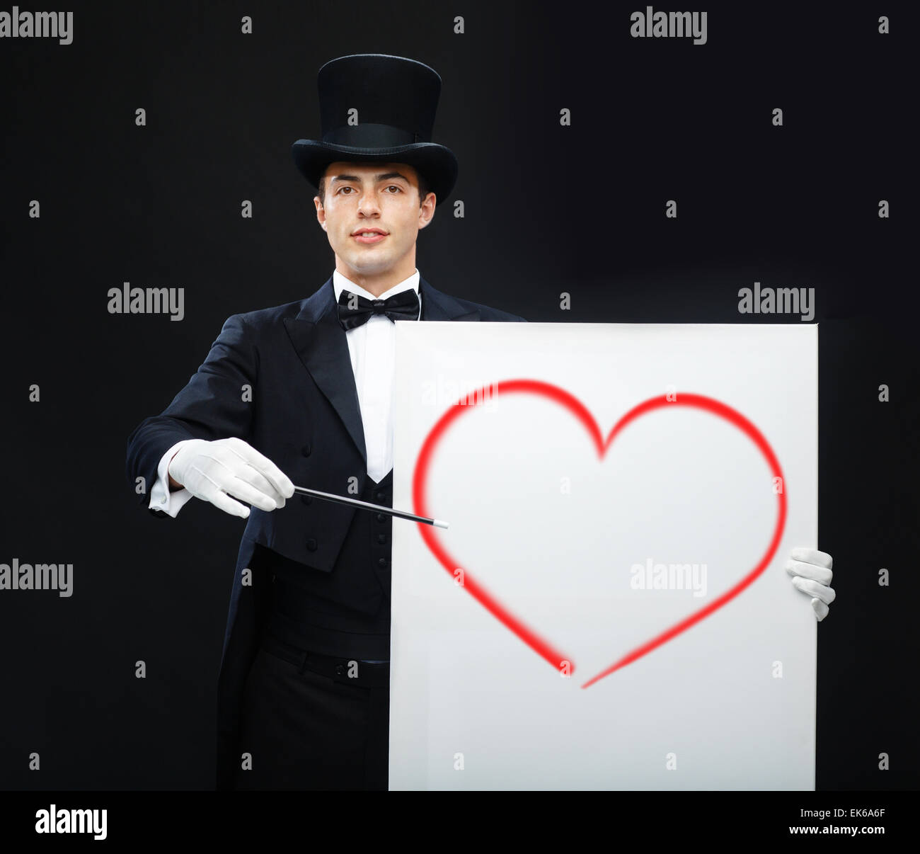 Magicien dans top hat avec Magic wand montrant trick Banque D'Images