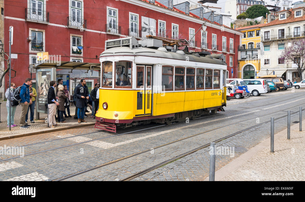 Lisbonne Portugal TRAMWAY ANCIEN JAUNE ET LES PASSAGERS DANS LE CENTRE DE LISBONNE Banque D'Images