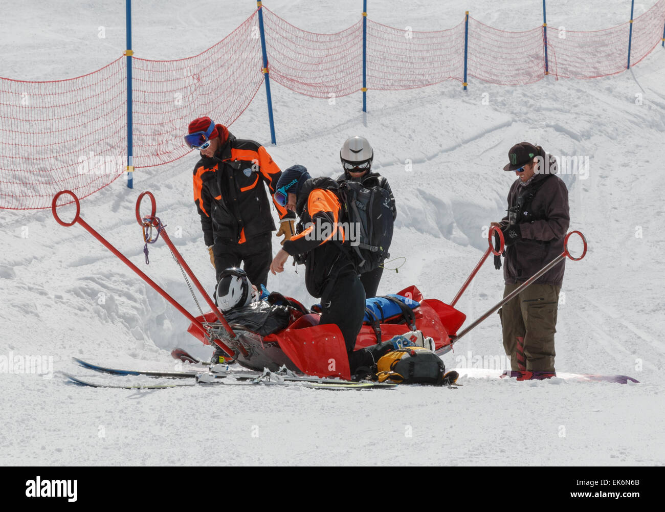Un skieur blessé sur un traîneau de sauvetage après avoir été aidé par la patrouille de ski dans les alpes ski après une chute sur une pente de ski. Banque D'Images