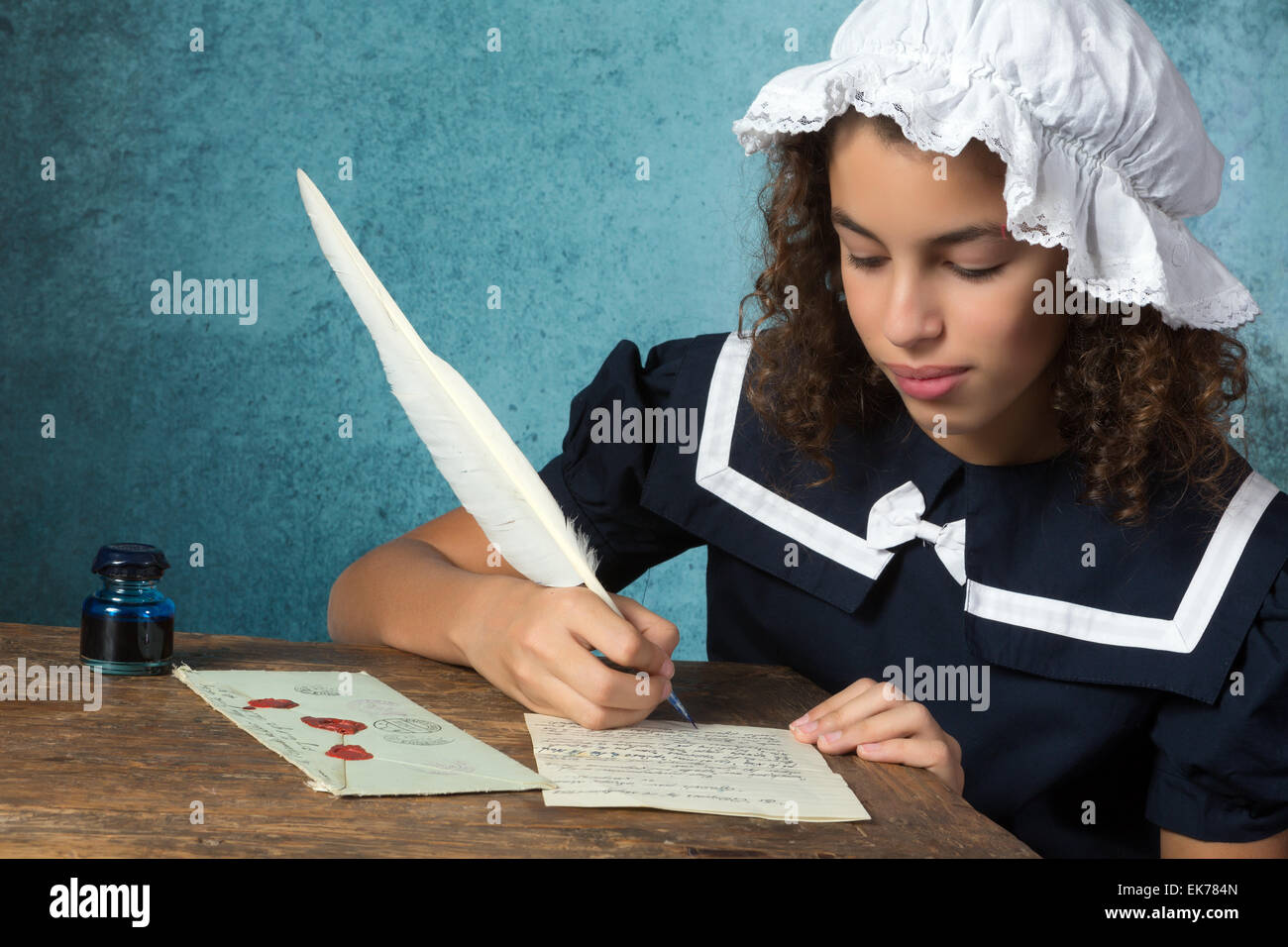 Jeune fille en robe vintage victorien et bonnet écrit une lettre Banque D'Images