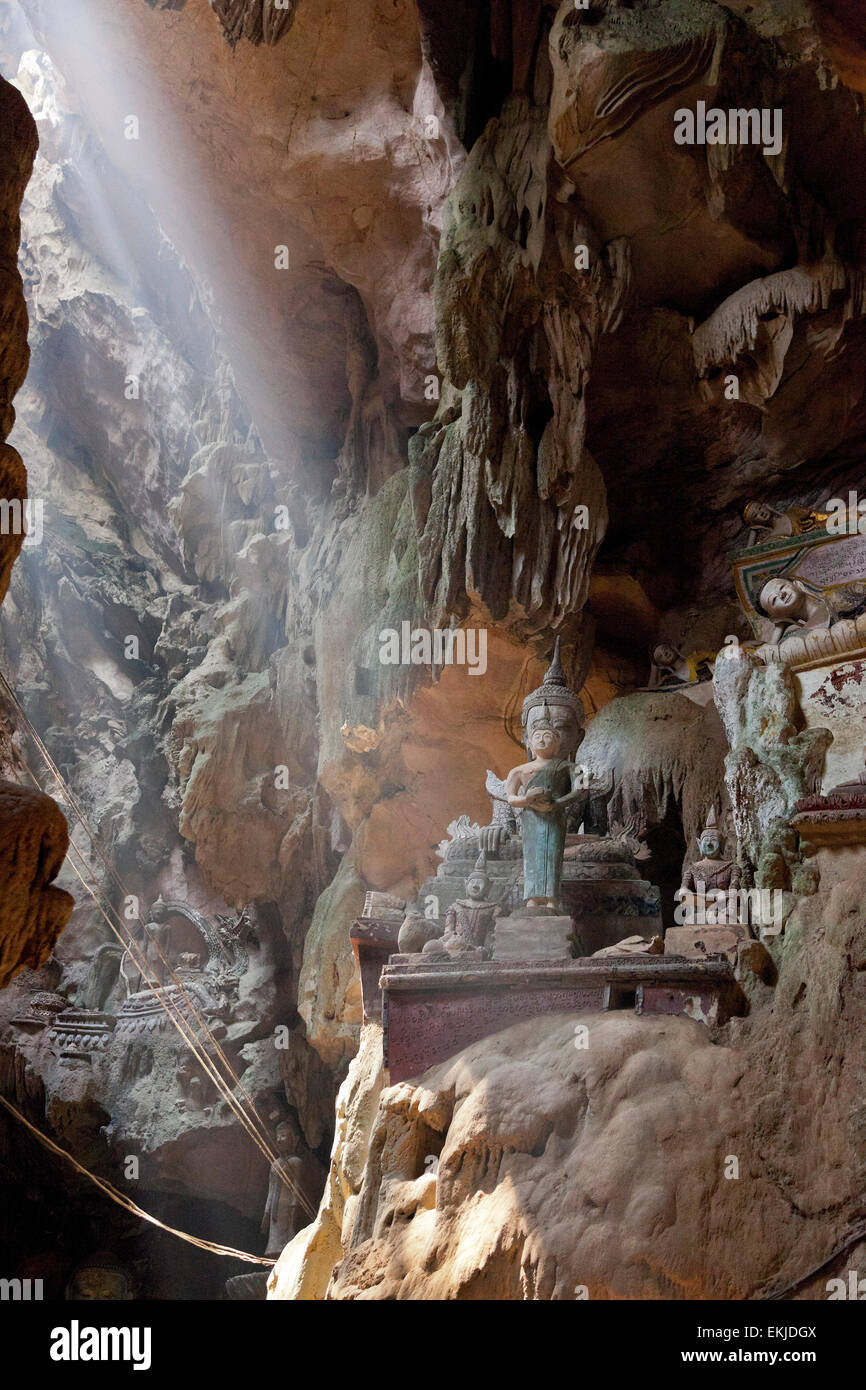 La grotte de Chiang Dao, Chiang Rai, Thaïlande du Nord. Formations calcaires, près de l'entrée avec des statues bouddhistes, sunbeam breaking Banque D'Images