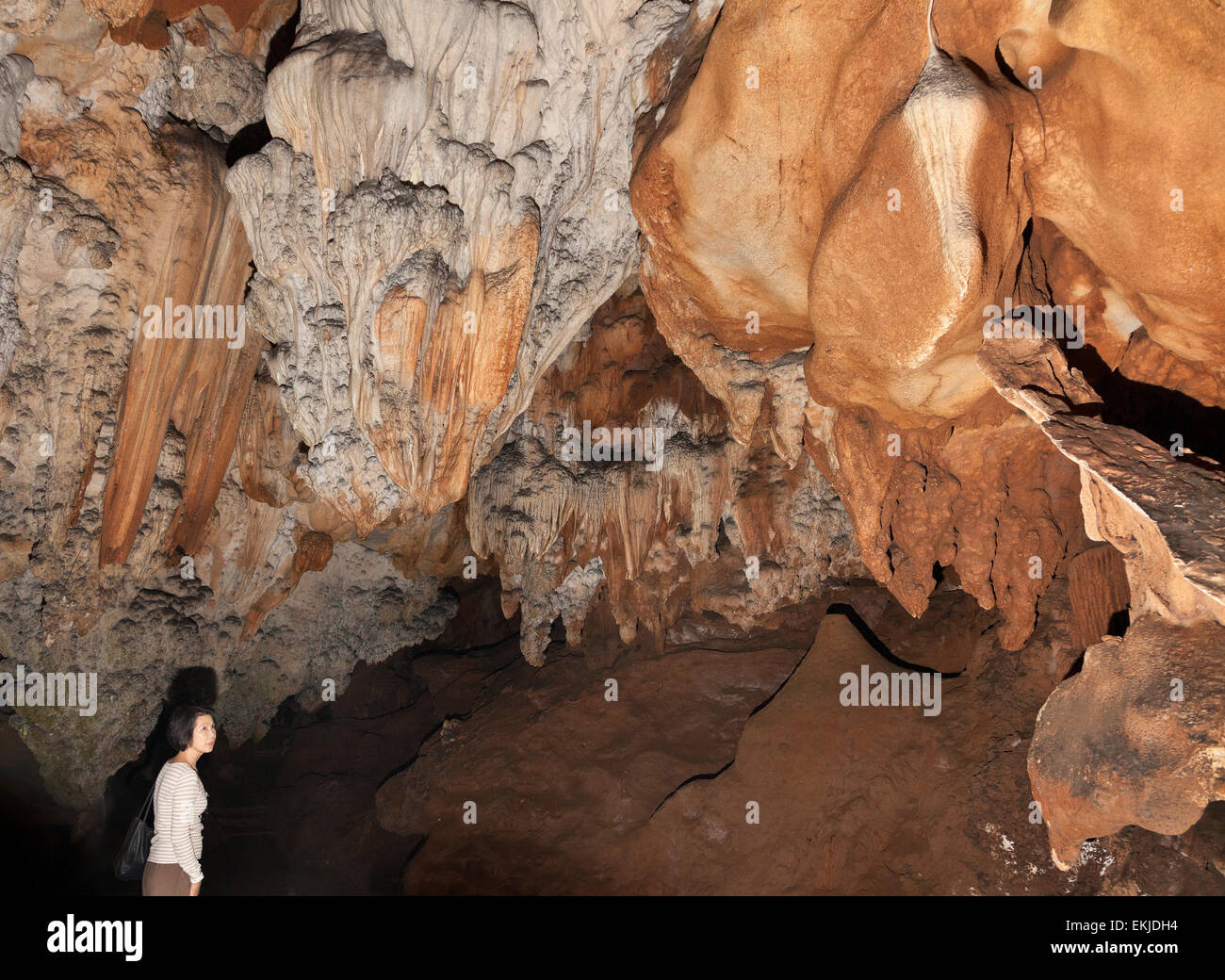 La grotte de Chiang Dao, Chiang Rai, Thaïlande du Nord. Formations calcaires. Dame visiteur admirant Banque D'Images
