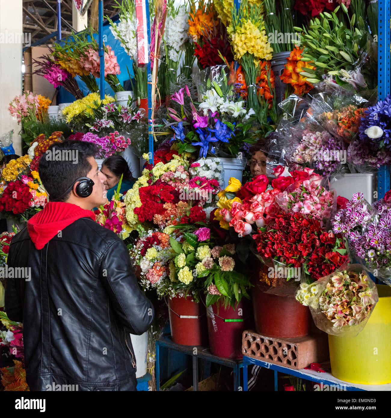 Pérou, Cusco. Marché de San Pedro. Vendeuse de fleurs et le client. Banque D'Images