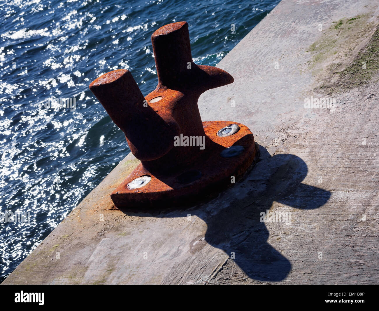 Un bollard rouillé sur un quai, utilisé pour l'amarrage des bateaux. Banque D'Images