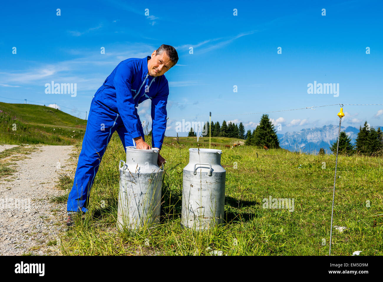 Agriculteur avec les contenants de lait Banque D'Images