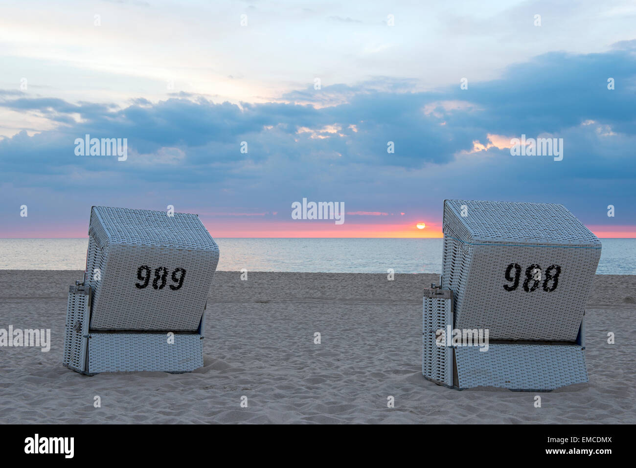 Allemagne, Schleswig-Holstein, Sylt, Westerland, chaises de plage sur la plage au coucher du soleil Banque D'Images