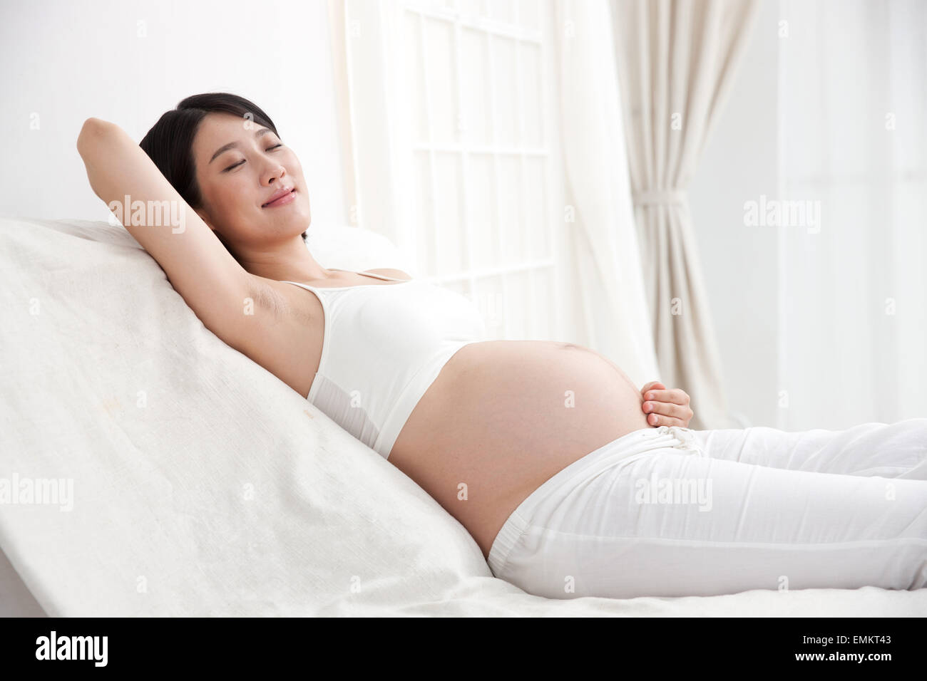 Les femmes enceintes sur le repos au lit Banque D'Images