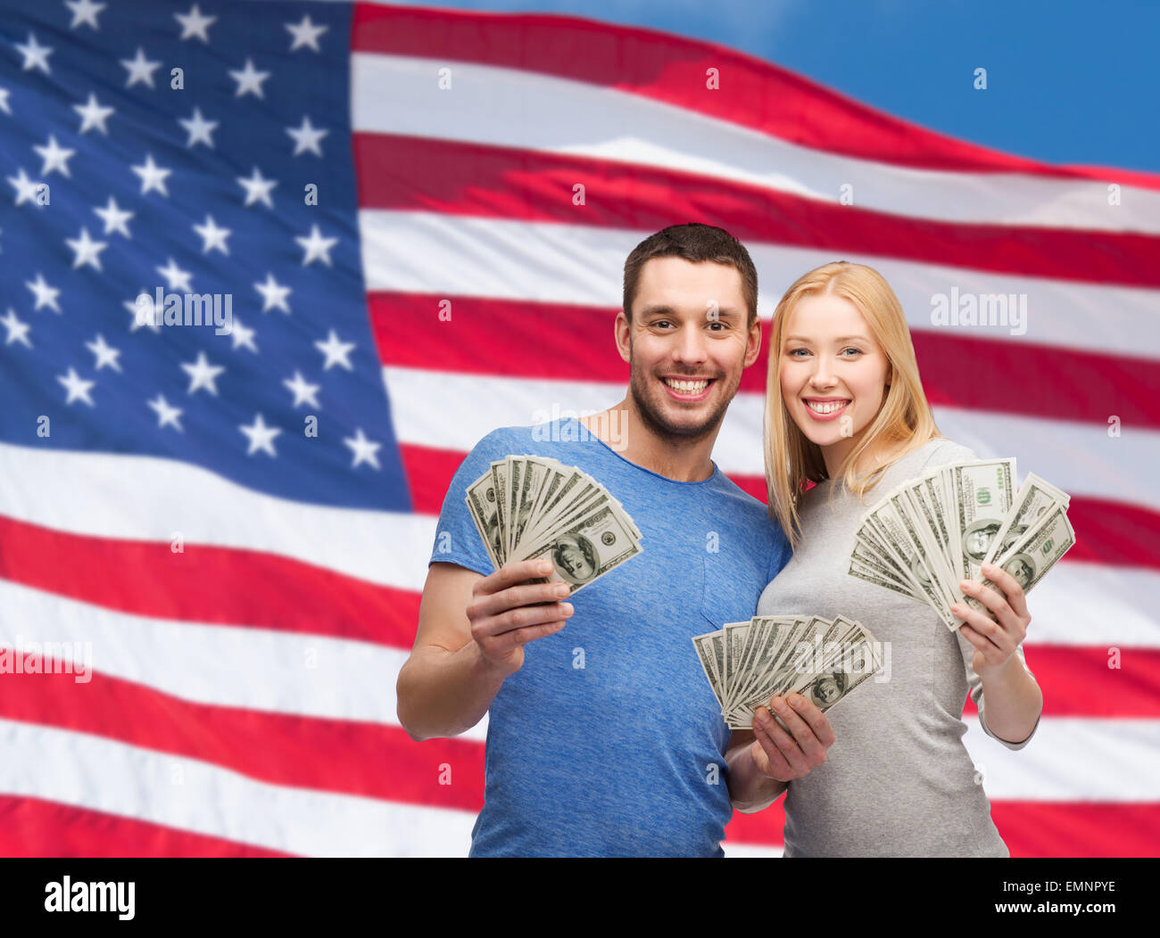 Smiling couple holding dollar cash money Banque D'Images