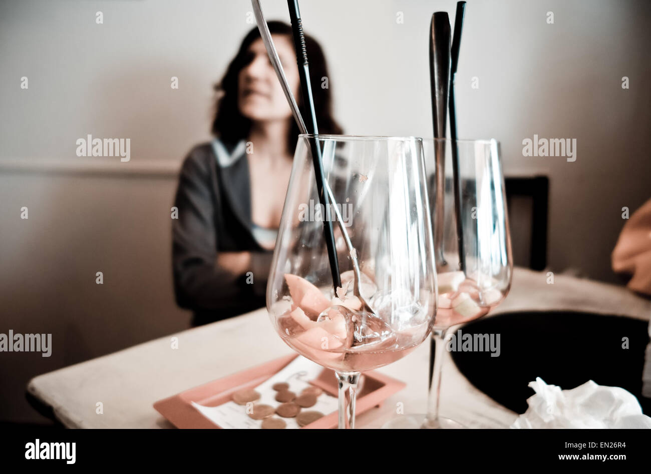 Femme en bar en attente, deux verres vides de Sangria avant-plan, avec facture payée à côté, l'Espagne. Banque D'Images