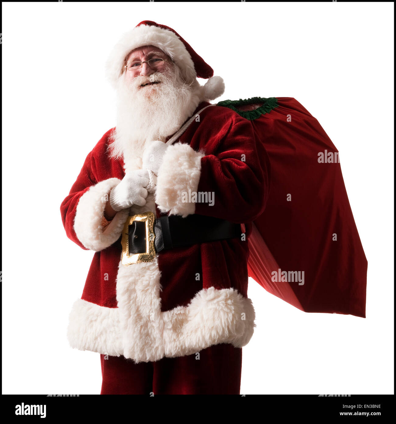 Père Noël transportant un sac de cadeaux Banque D'Images
