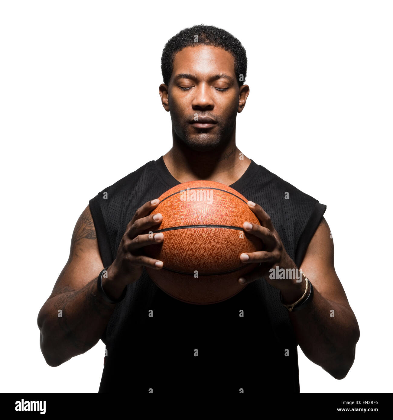 Studio shot of basketball player holding ball Banque D'Images