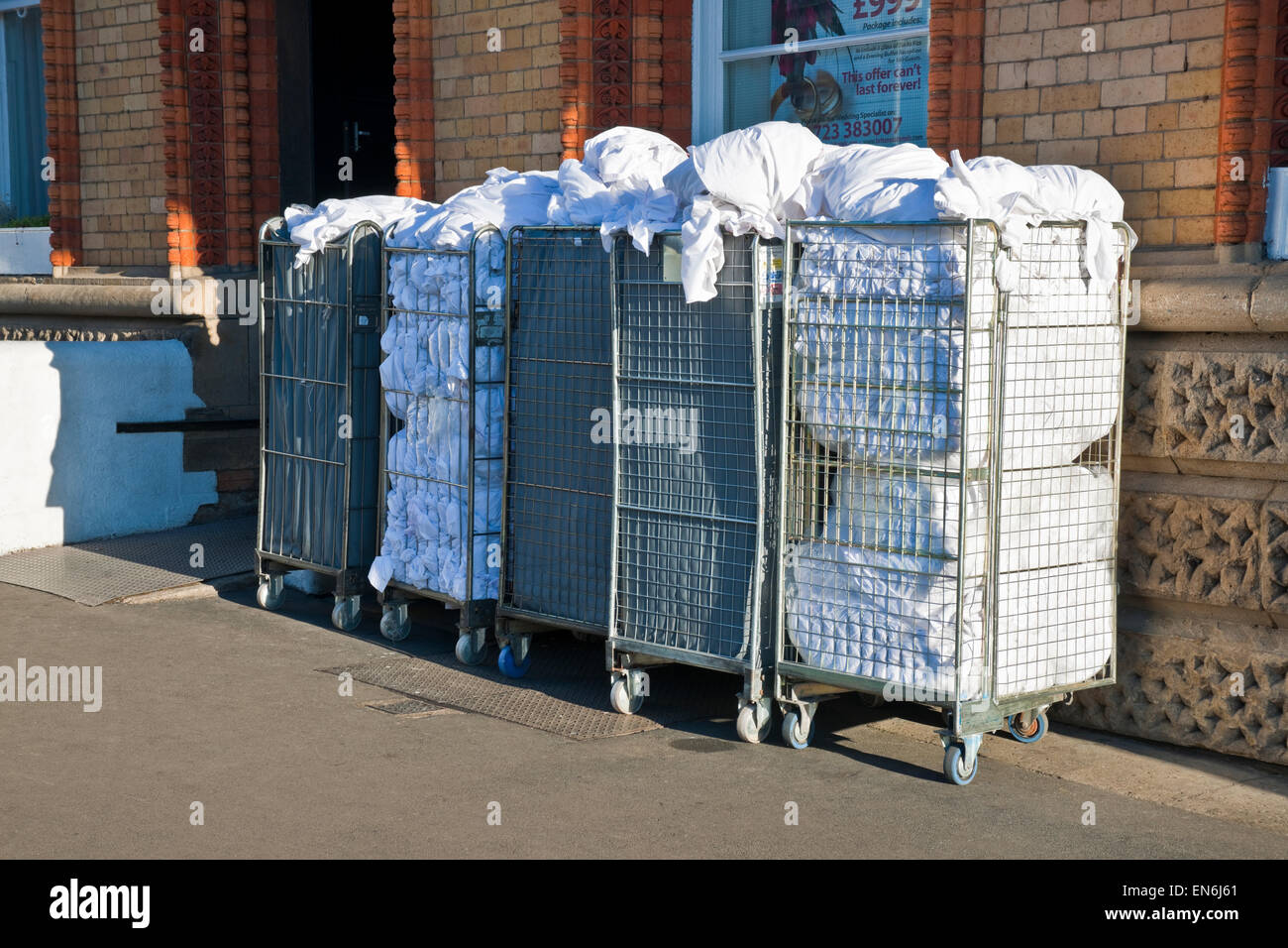 Chariots contenant du linge usagé en attente de récupération à l'extérieur d'un hôtel Scarborough North Yorkshire Angleterre Royaume-Uni Grande-Bretagne Banque D'Images