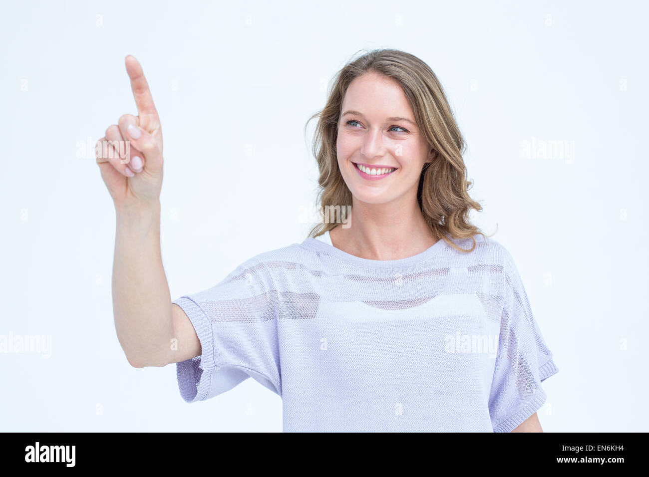 Jolie femme pointant avec son doigt Banque D'Images