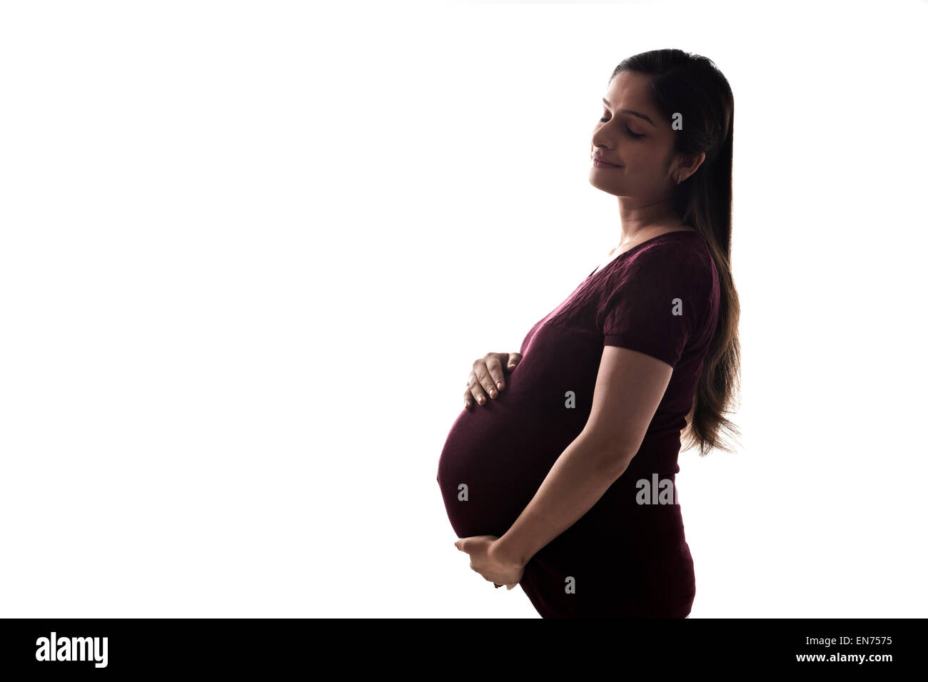 Pregnant woman holding sa Banque D'Images