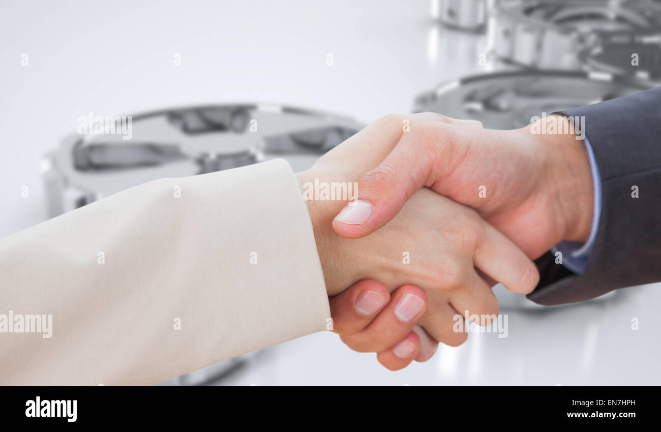 Image composite de close up on partners shaking hands Banque D'Images