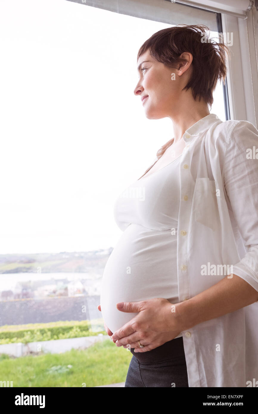 Pregnant woman holding her bump Banque D'Images