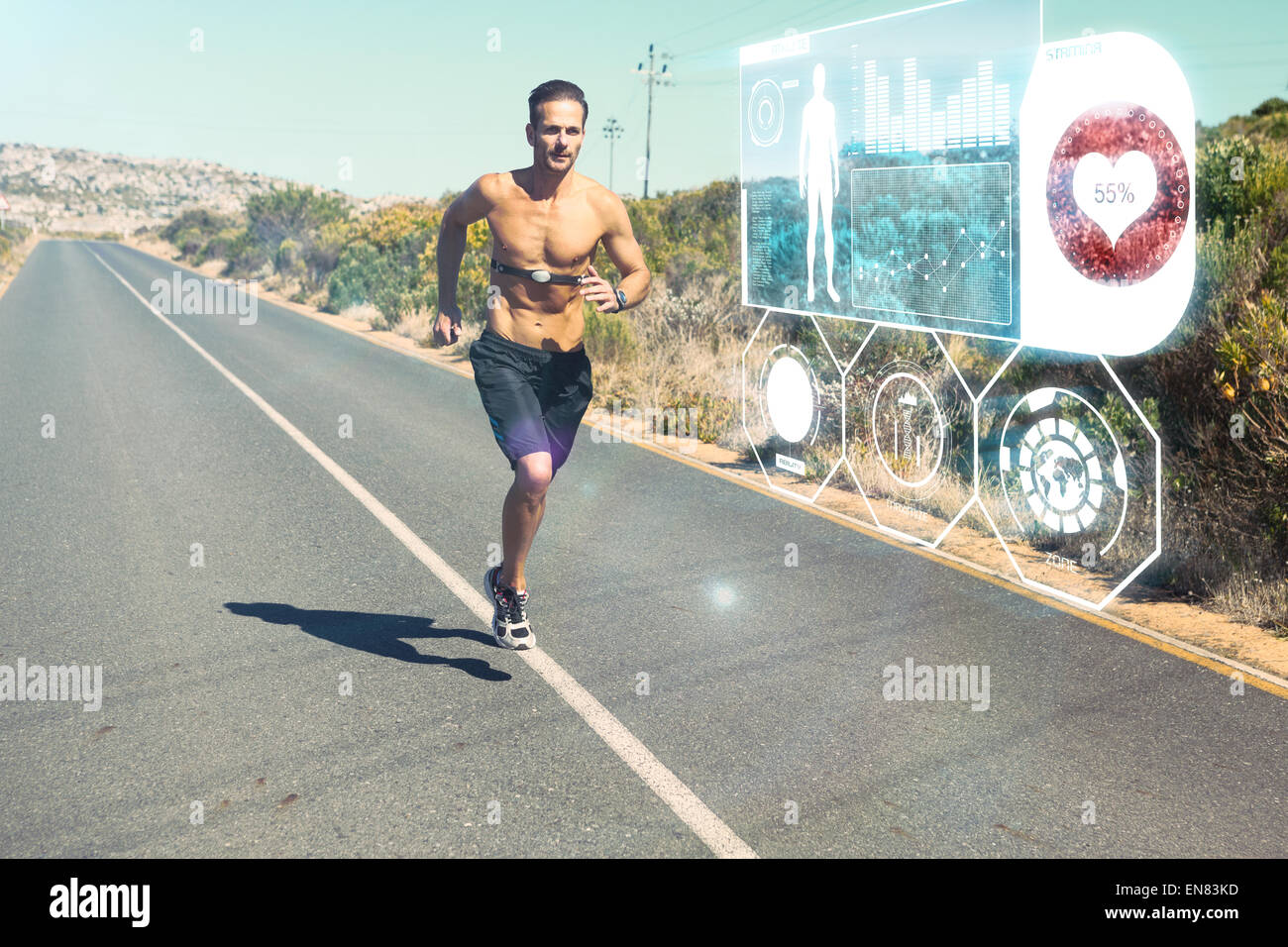 Image composite de l'athletic man jogging sur route ouverte avec moniteur autour de poitrine Banque D'Images