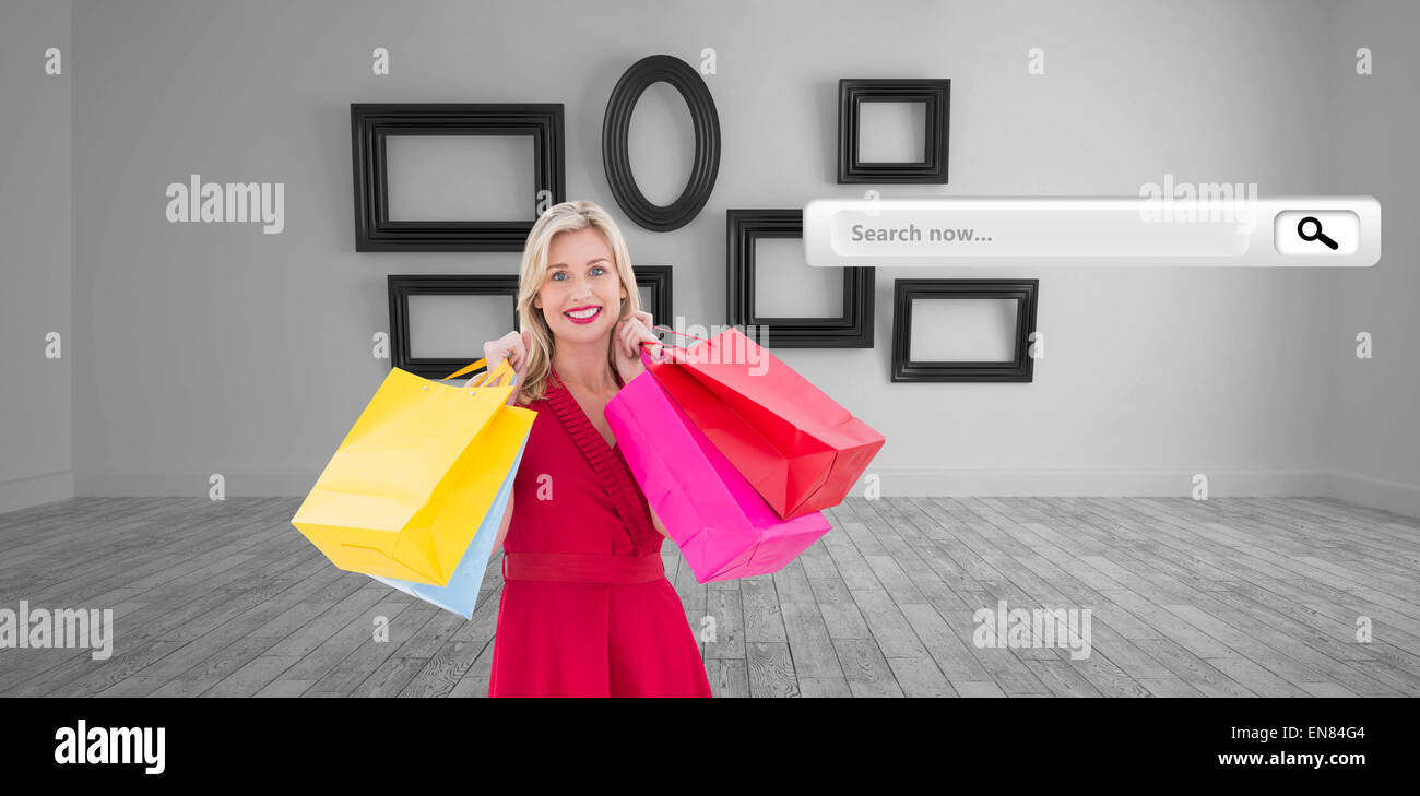 Composite image blonde en robe rouge holding shopping bags Banque D'Images