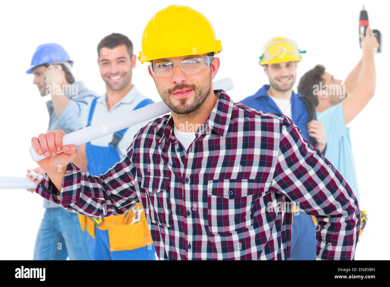 Image composite de handyman holding rolled up plan Banque D'Images