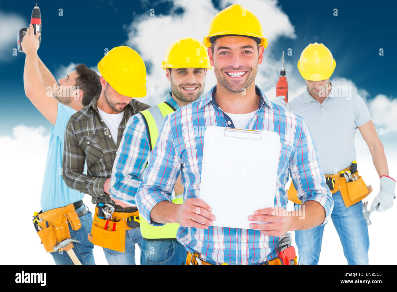 Image composite de portrait of smiling manual worker holding clipboard Banque D'Images