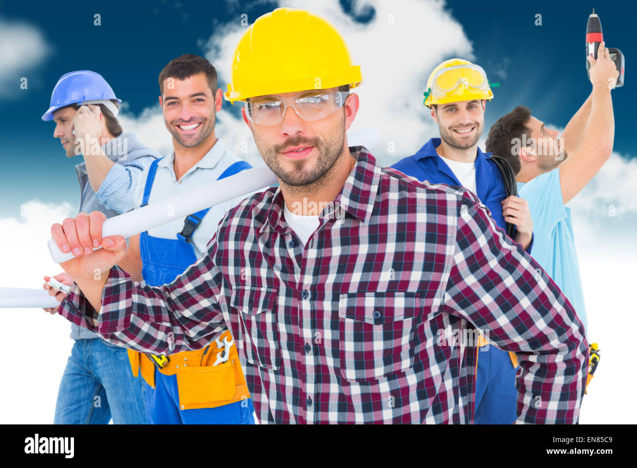 Image composite de handyman holding rolled up plan Banque D'Images