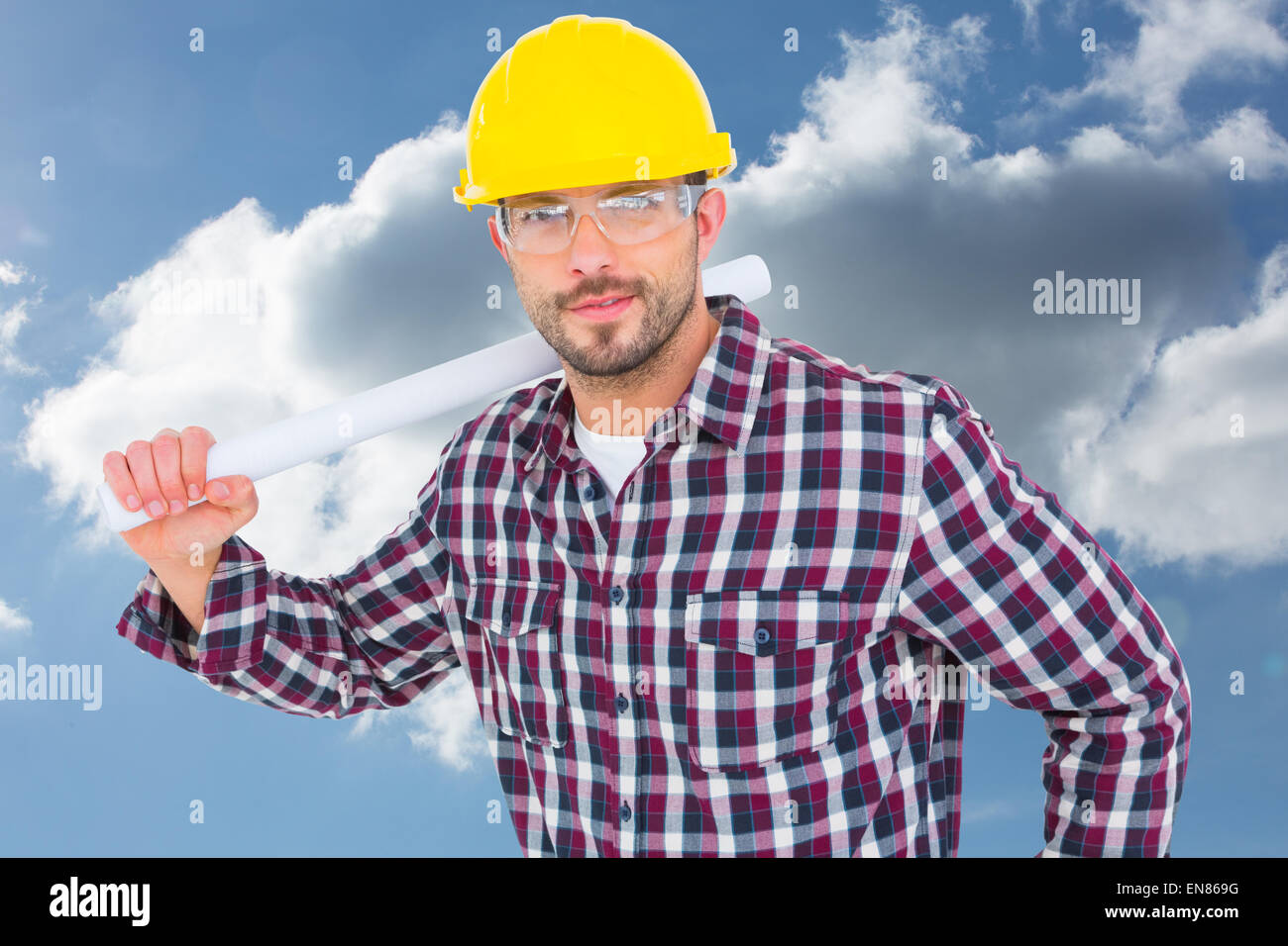 Image composite de handyman holding rolled up plan Banque D'Images