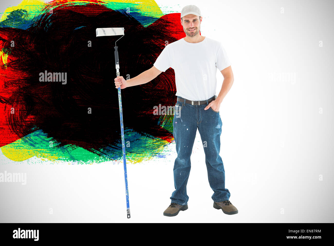 Image composite de l'homme confiant holding paint roller sur fond blanc Banque D'Images