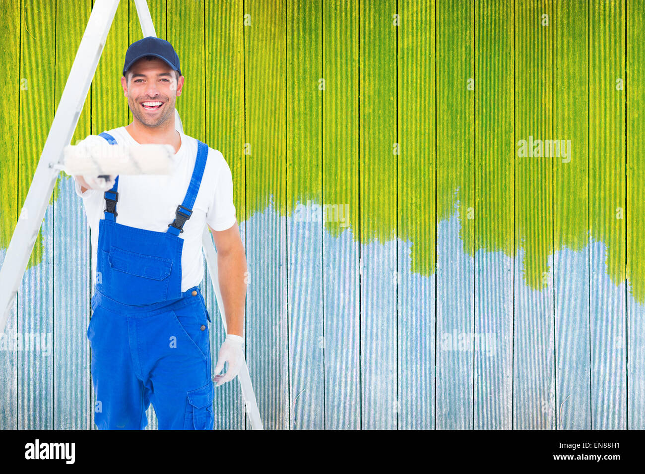 Image composite de l'homme à l'aide de rouleau à peindre sur fond blanc Banque D'Images