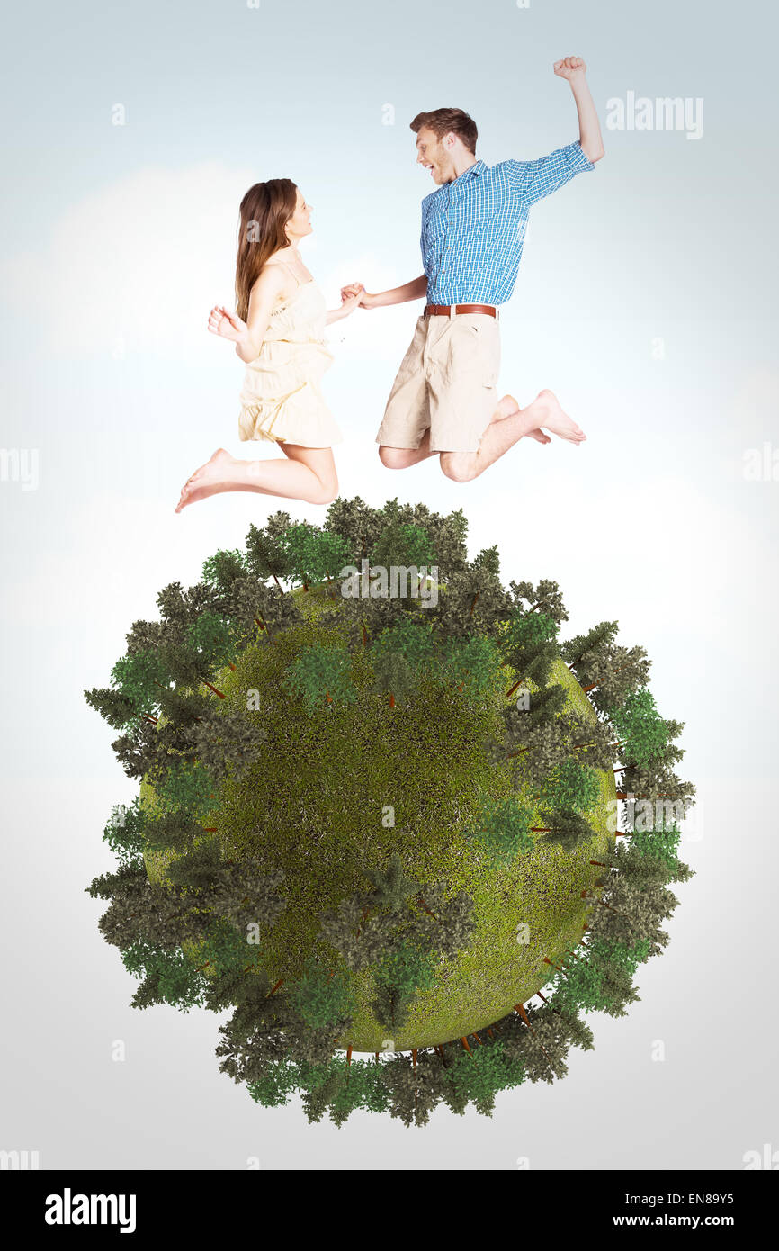 Image composite de cheerful young couple jumping Banque D'Images
