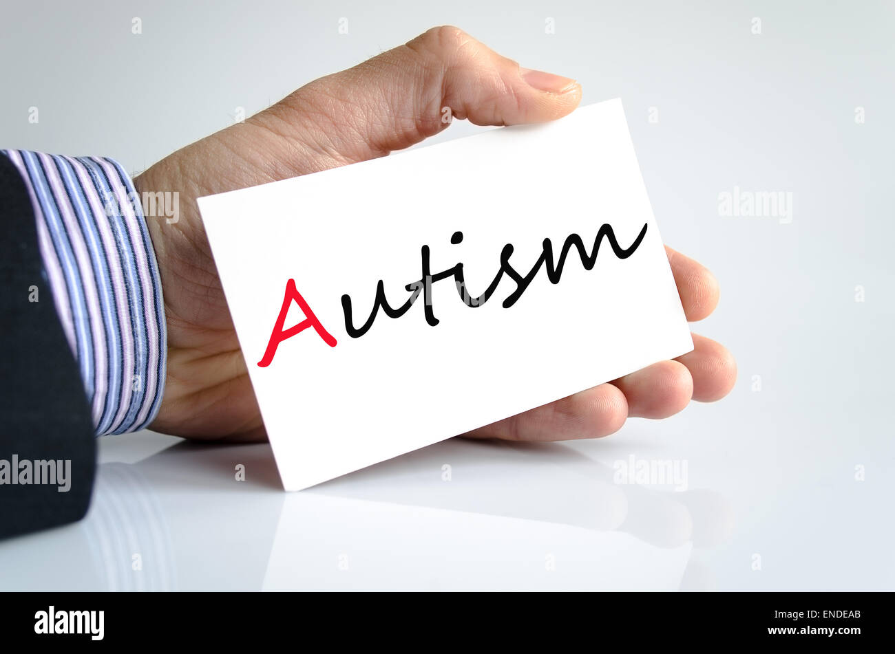 Business man hand writing autisme Banque D'Images