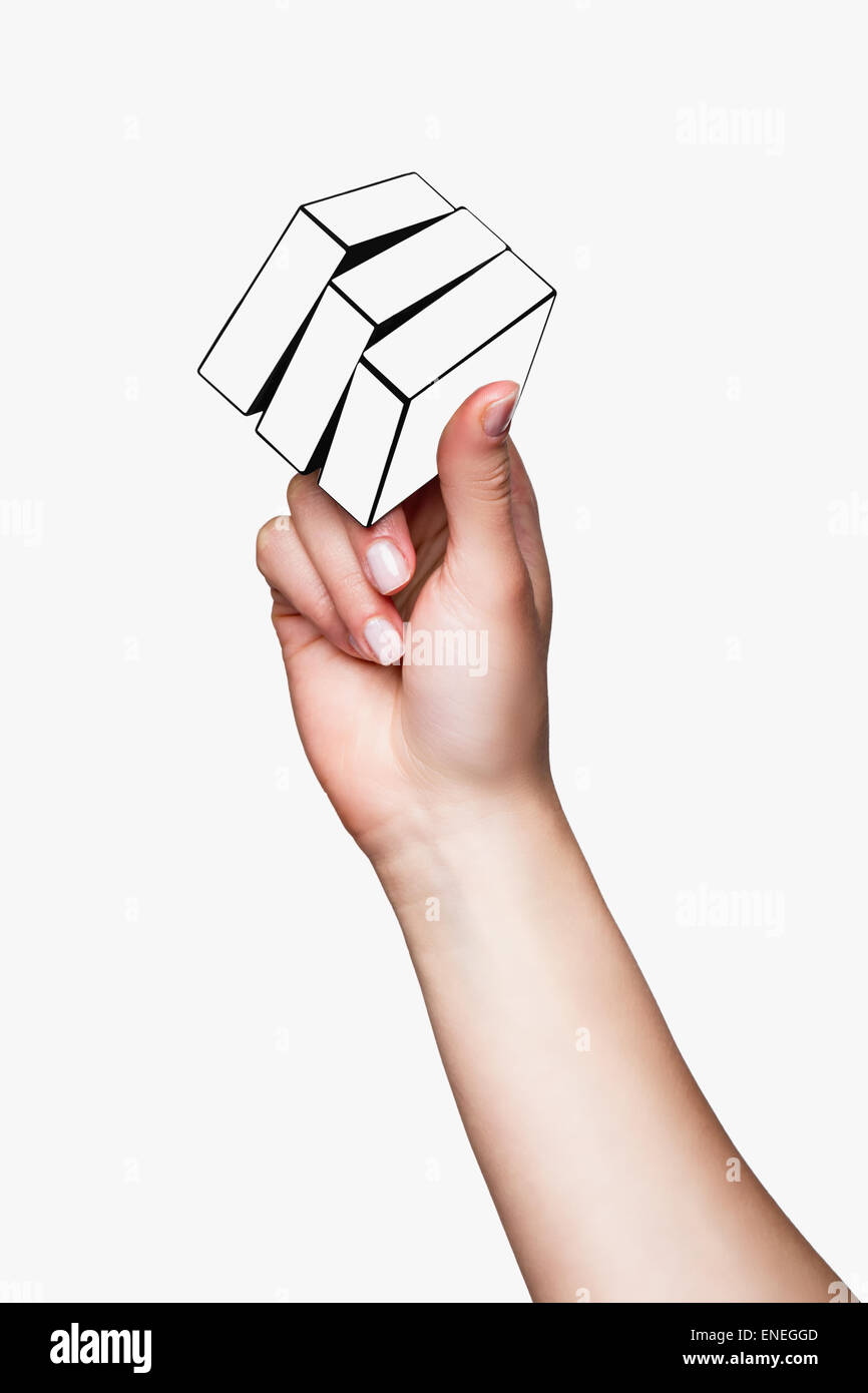 Hand holding white cube sur fond blanc Banque D'Images