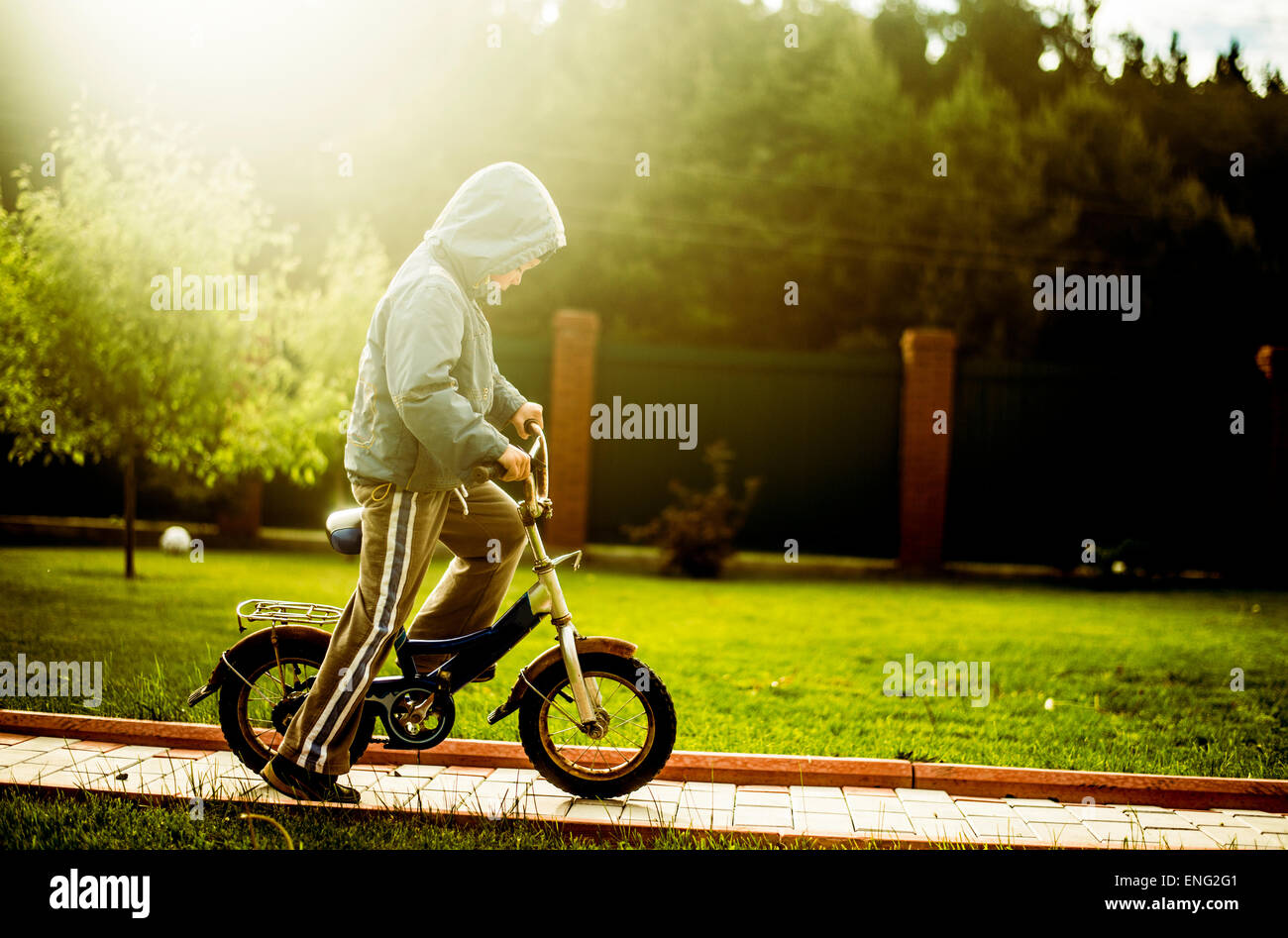 Caucasian boy riding bicycle in backyard Banque D'Images