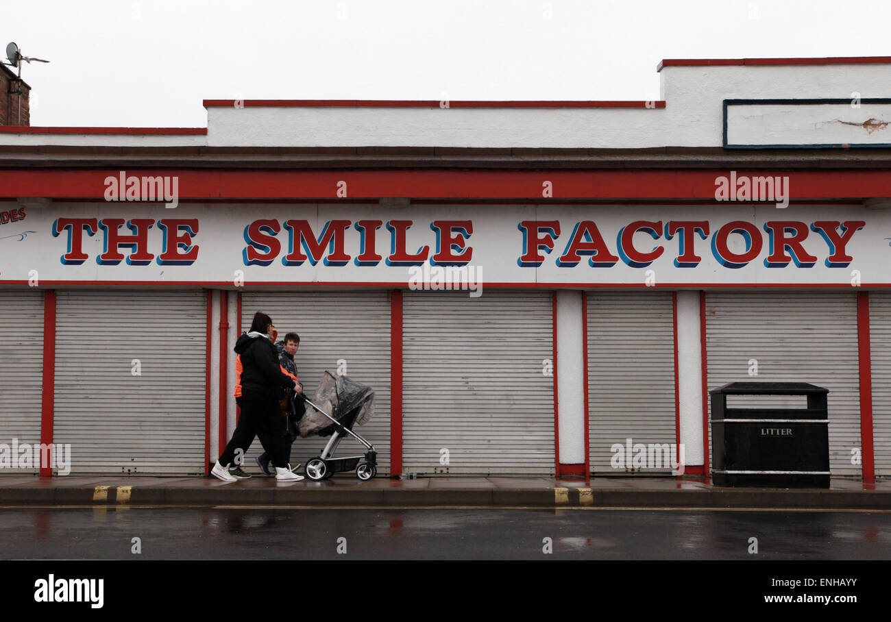 Journée humide en Cleethorpes, une famille devant l'usine en sourire près de Grimsby Grimsby Banque D'Images