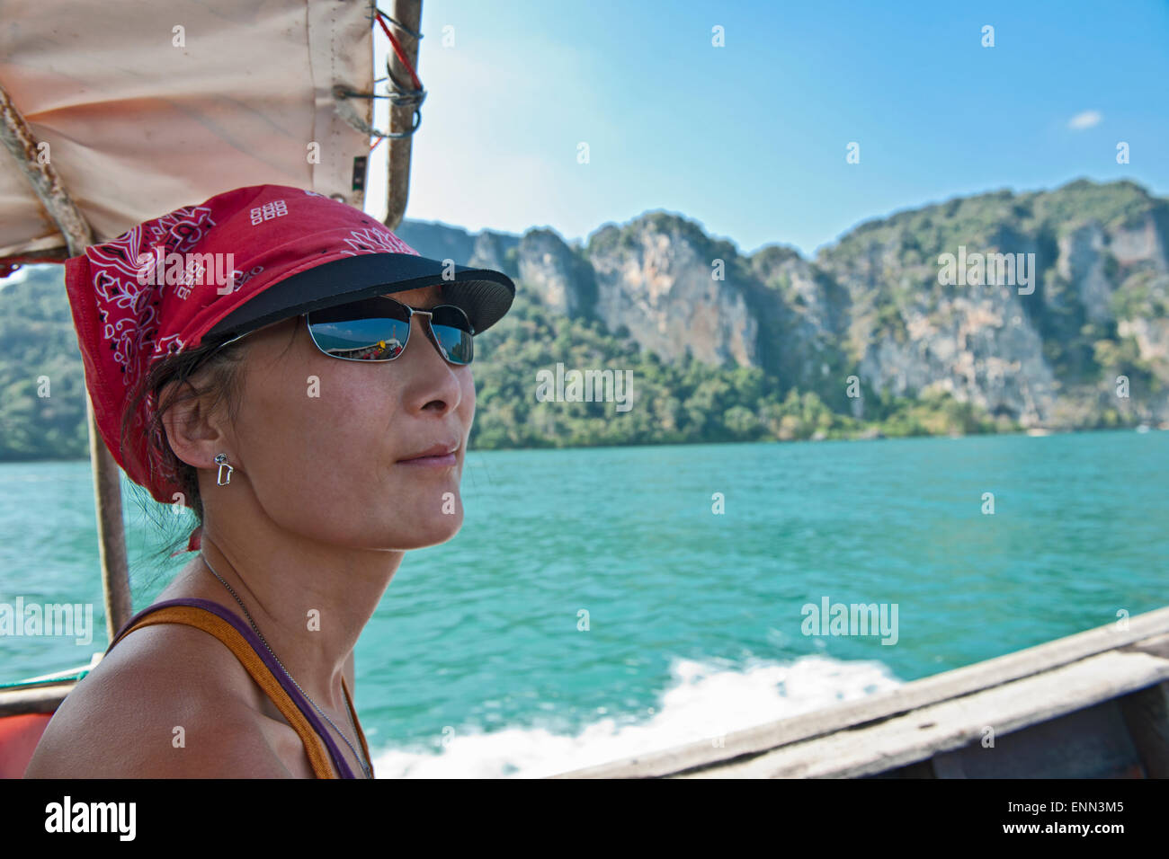 Femme passant Railay Beach en Thaïlande dans un bateau longue queue Banque D'Images