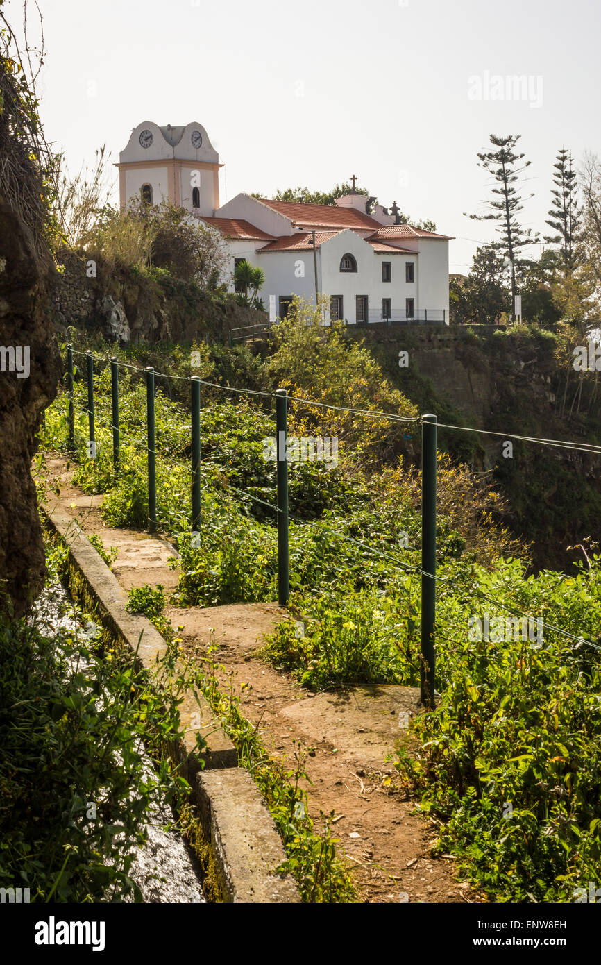 Canal d'irrigation et sentier Levada de Levada Nova, Ponta do Sol, à Madère. Laurisilva fôret subtropical. Lombada chapelle. Banque D'Images