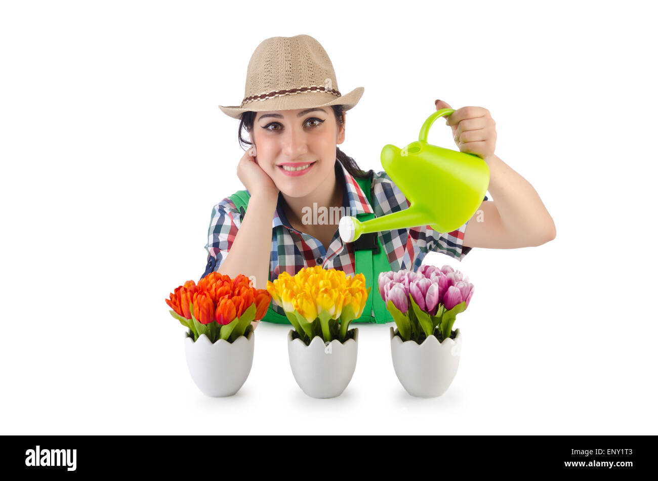 Girl watering plants on white Banque D'Images