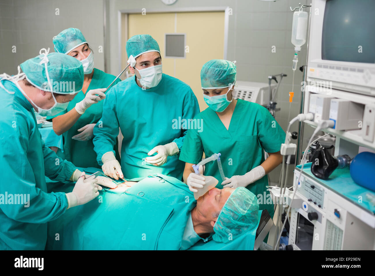 Séchage infirmière front d'un chirurgien à côté d'un patient Banque D'Images
