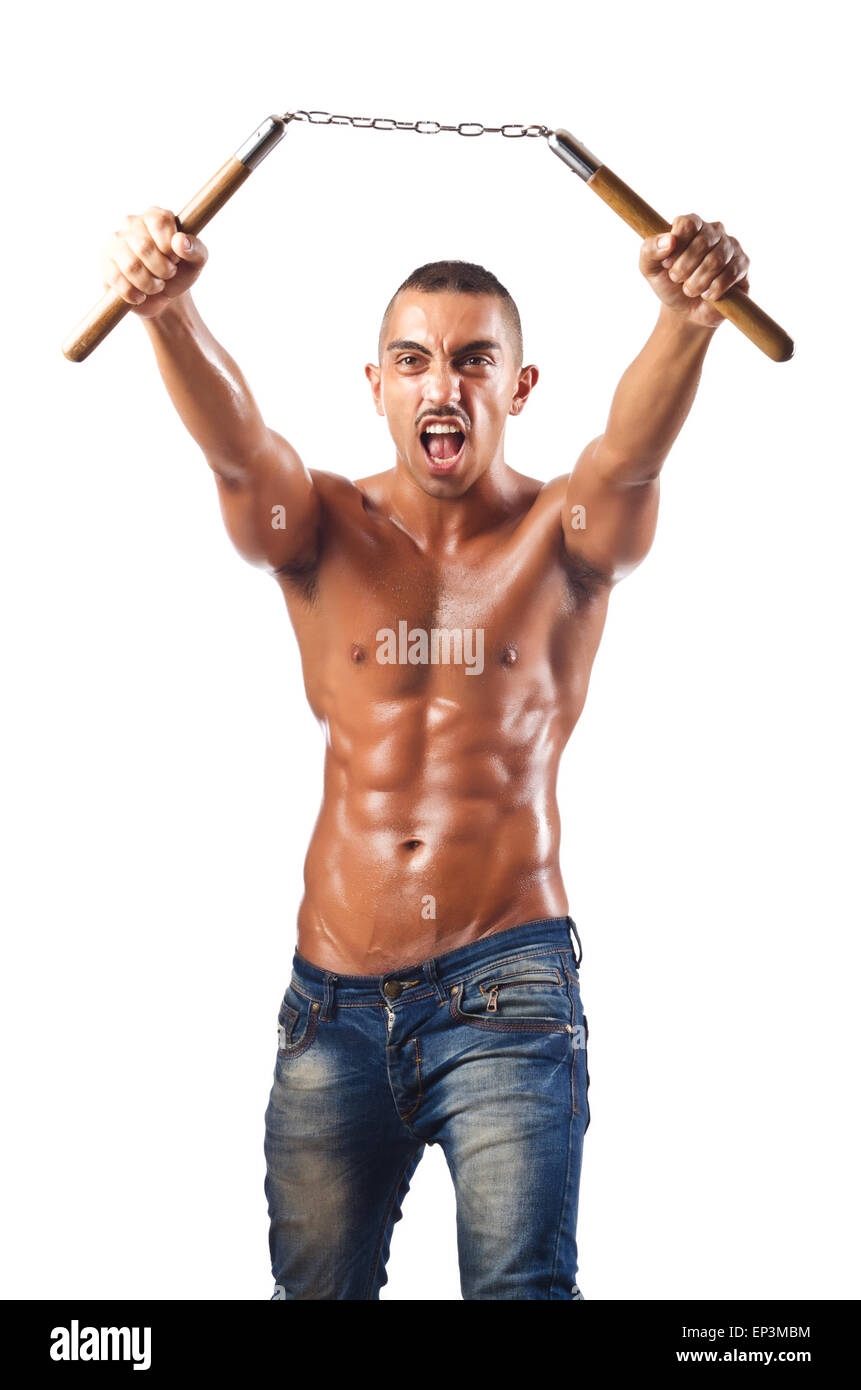 L'homme dans les arts martiaux concept avec nunchucks Banque D'Images