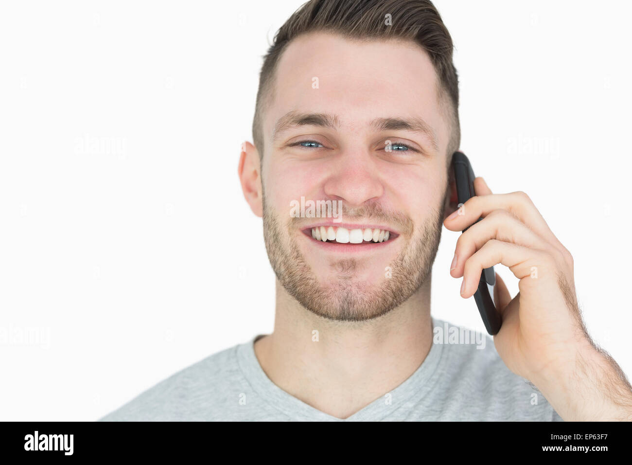 Closeup portrait of young man using mobile phone Banque D'Images