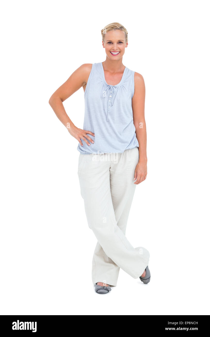 Pretty woman smiling with hands on hips looking at camera Banque D'Images