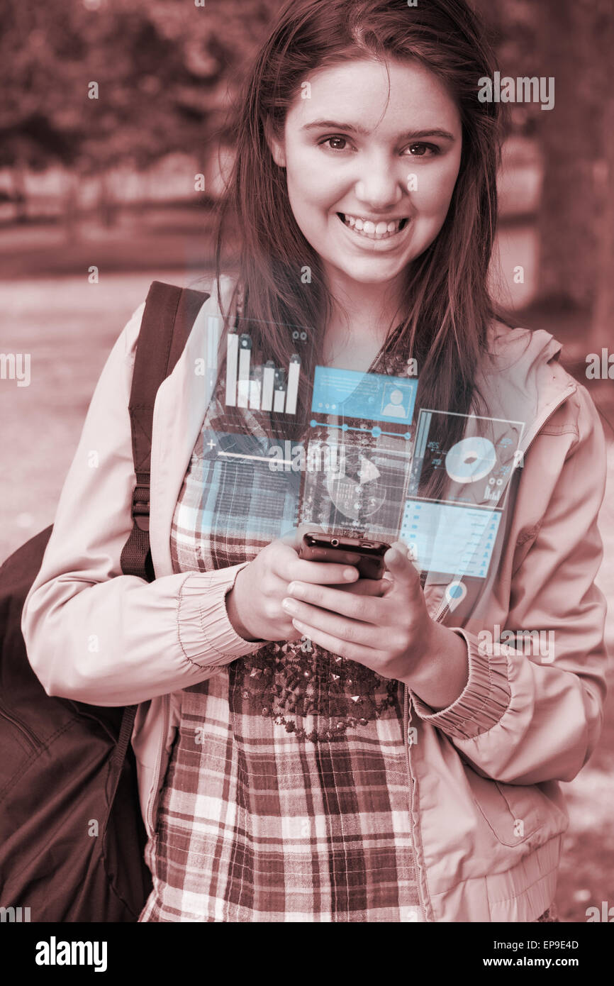 Smiling young woman working on her futuristic smartphone Banque D'Images