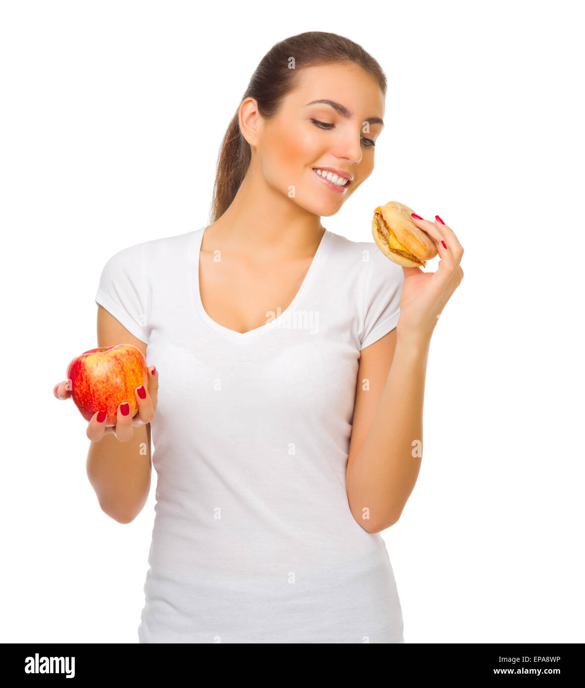 Young smiling girl avec hamburger et isolés d'apple Banque D'Images