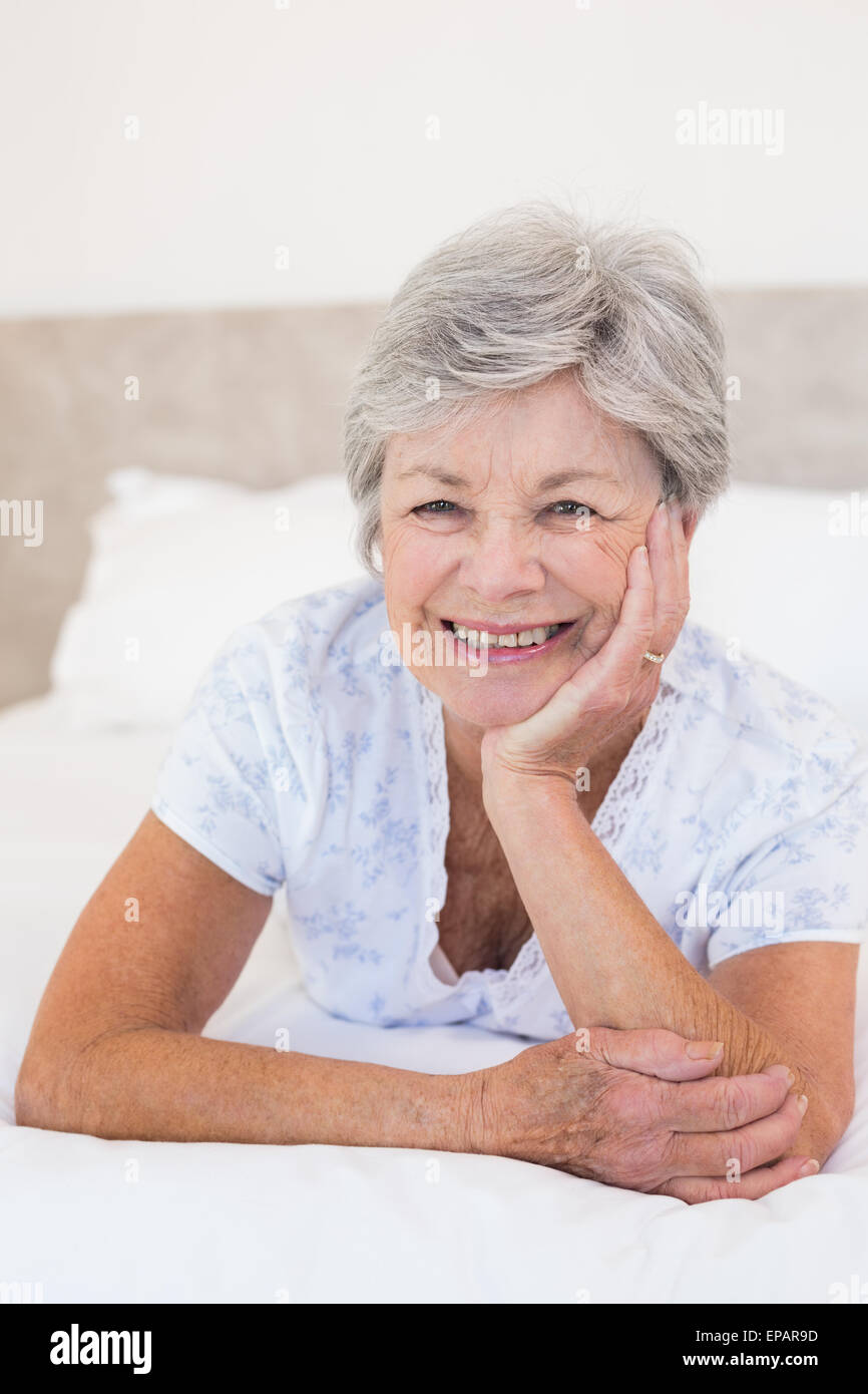 Happy senior woman Lying in Bed Banque D'Images