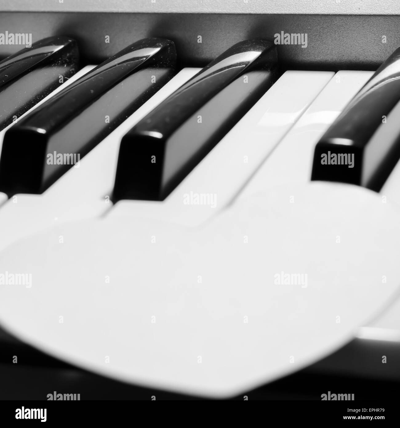 Coeur de papier sur piano clavier noir et blanc couleur Banque D'Images
