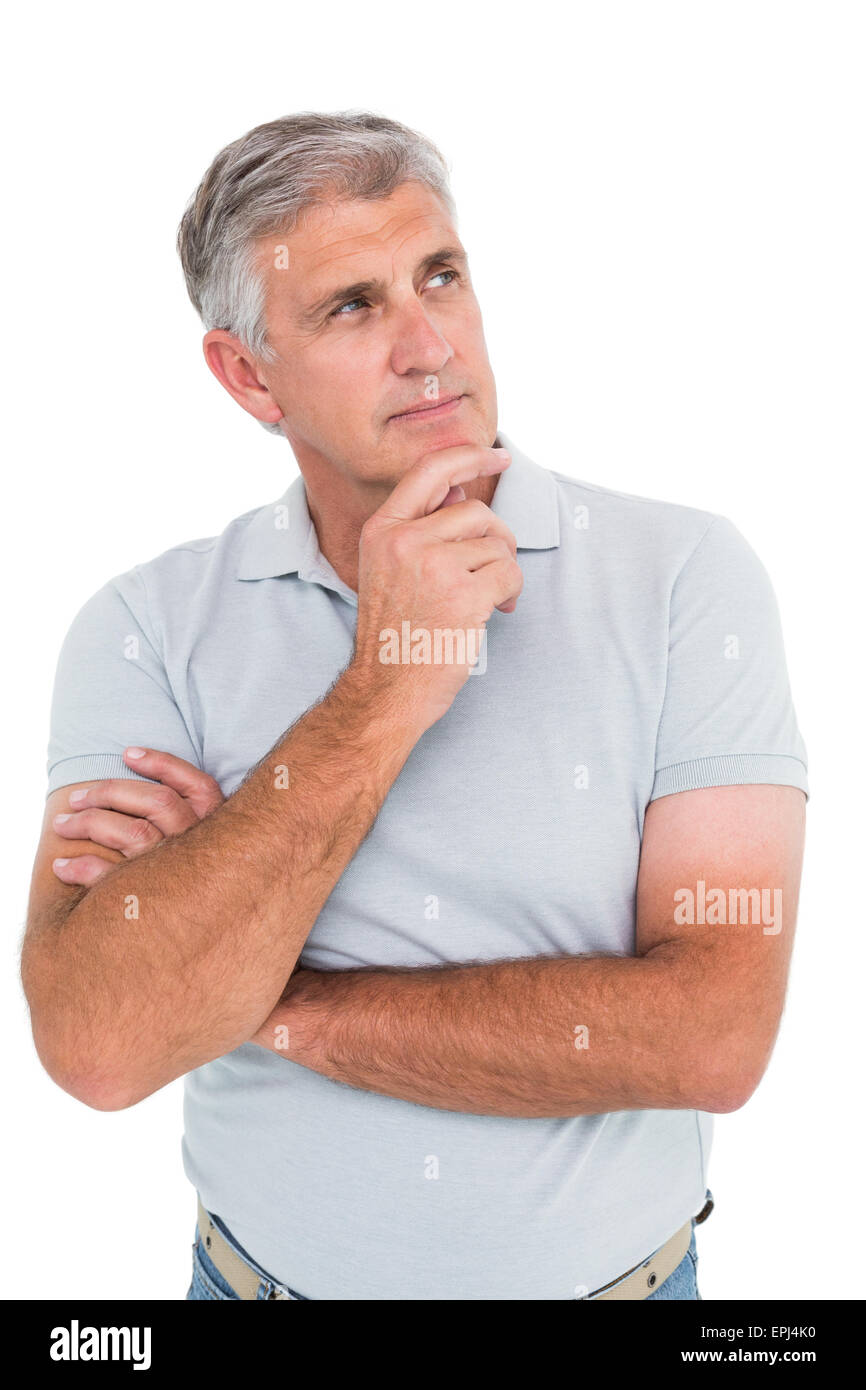 Casual man thinking with hand on chin Banque D'Images