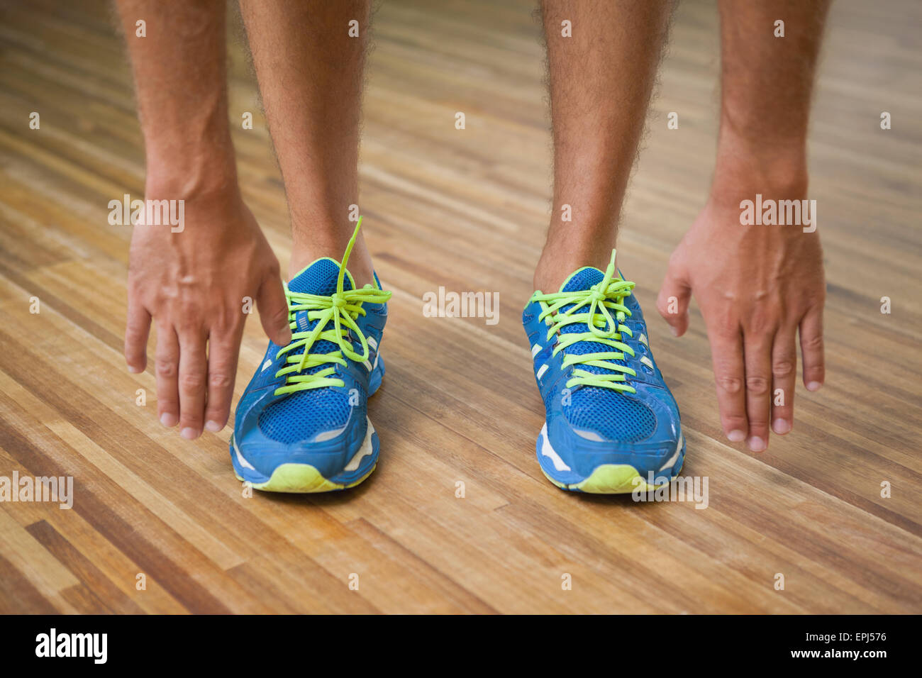 La section basse de l'homme dans les chaussures de sports in fitness studio Banque D'Images